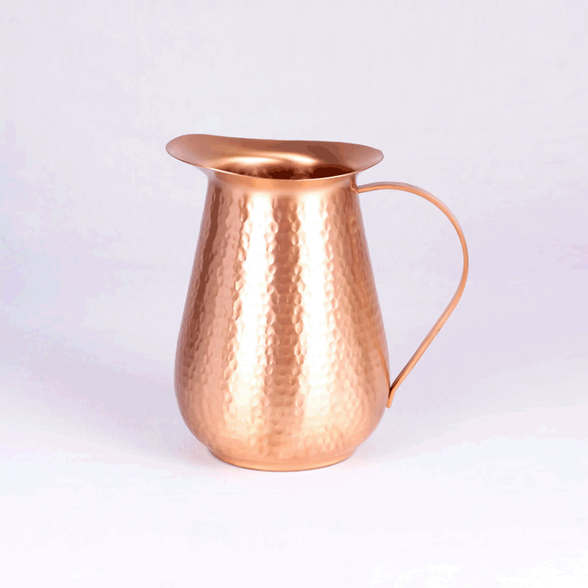pure copper water jug with hammered design.